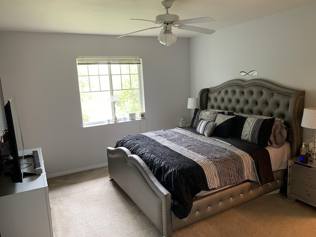 bedroom with baseboards, light colored carpet, and ceiling fan