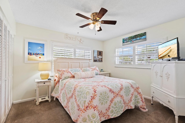 carpeted bedroom with a closet, ceiling fan, and a textured ceiling