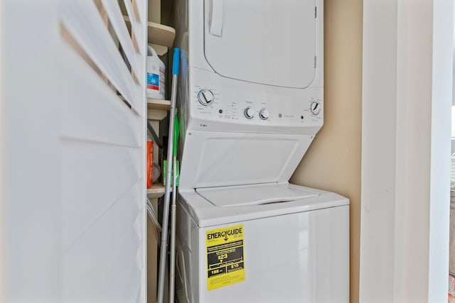 washroom featuring stacked washer and clothes dryer