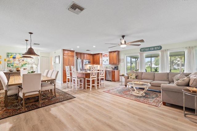 411 Sandpiper Dr Unit A, Fort Pierce, FL 34950 - living room featuring visible vents, ceiling fan, a textured ceiling, light wood-type flooring, and recessed lighting