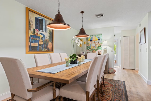 411 Sandpiper Dr Unit A, Fort Pierce, FL 34950 - dining room with a textured ceiling, wood finished floors, visible vents, and baseboards