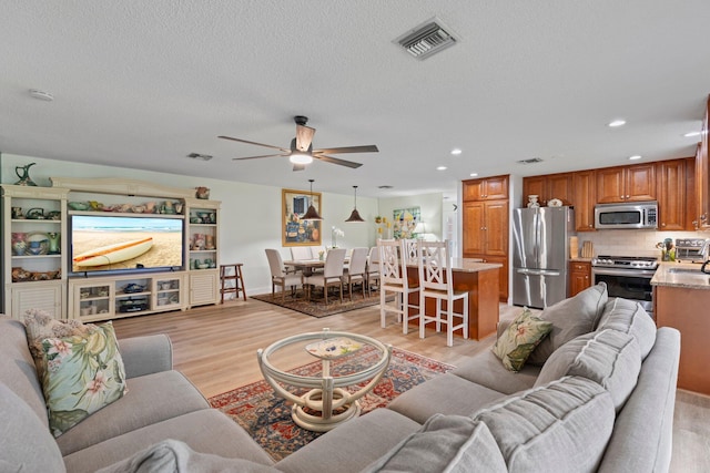 411 Sandpiper Dr Unit A, Fort Pierce, FL 34950 - living area featuring light wood-type flooring, visible vents, and recessed lighting