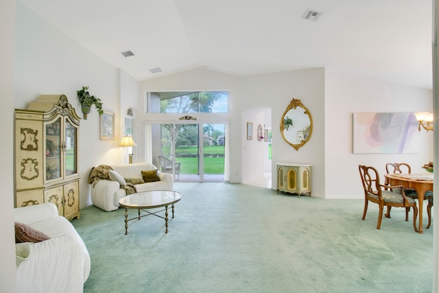 living area with lofted ceiling and carpet floors