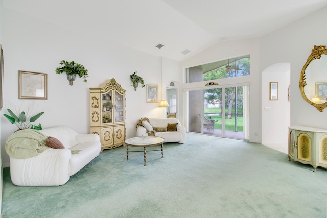 living room with vaulted ceiling and carpet floors