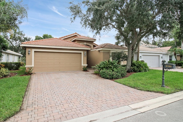 view of front of home featuring a front yard and a garage