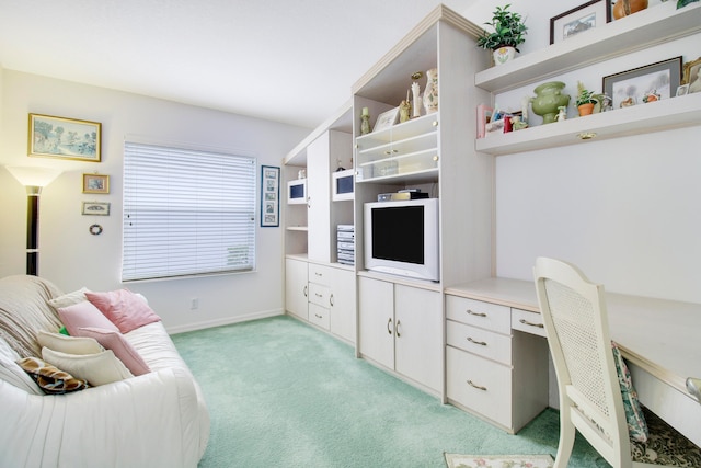 office area featuring light carpet and built in desk