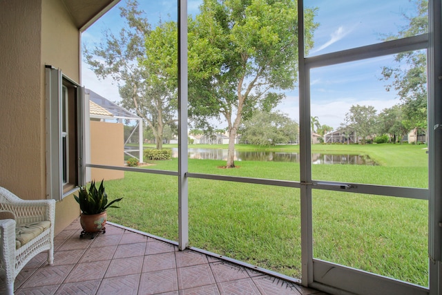 unfurnished sunroom featuring a water view