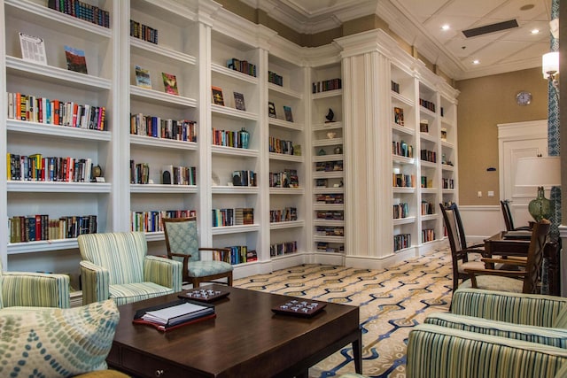 carpeted home office with built in features and ornamental molding