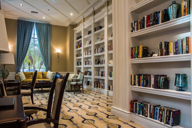 living area featuring crown molding and carpet floors