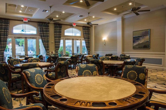 dining space with french doors, coffered ceiling, a high ceiling, and ceiling fan