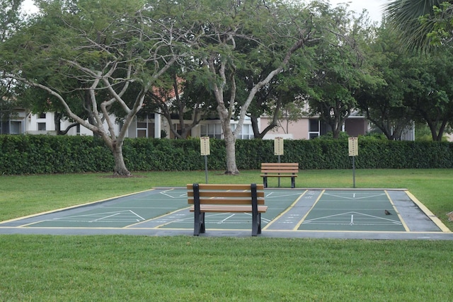 view of property's community with a lawn