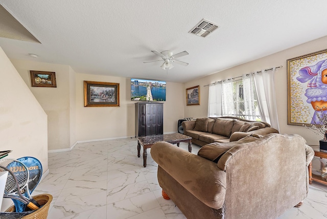 tiled living room featuring ceiling fan and a textured ceiling