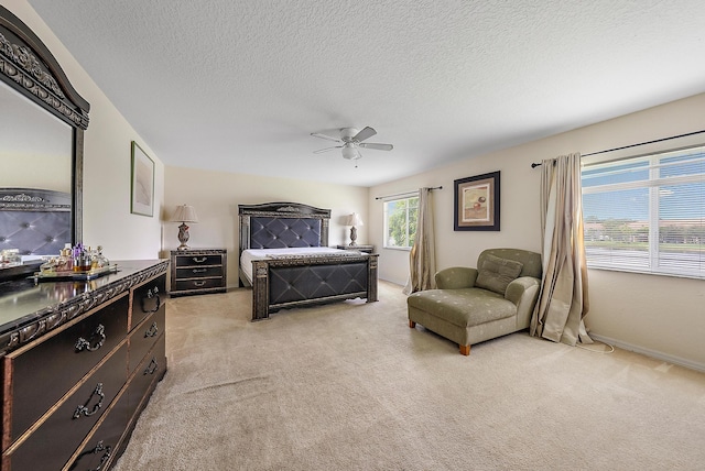 carpeted bedroom with a textured ceiling and ceiling fan