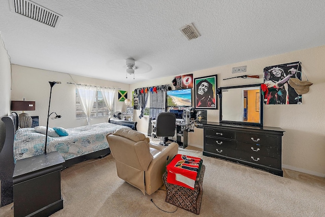 carpeted bedroom with ceiling fan and a textured ceiling