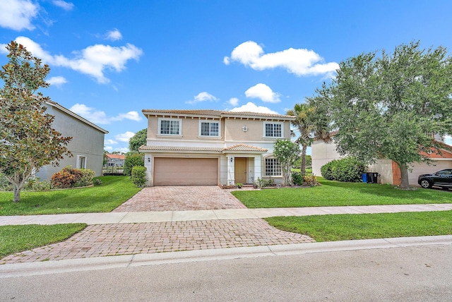 view of front of house with a garage and a front lawn