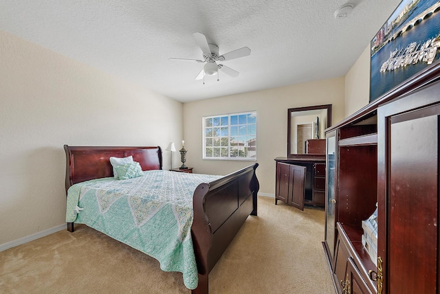 carpeted bedroom featuring a textured ceiling and ceiling fan