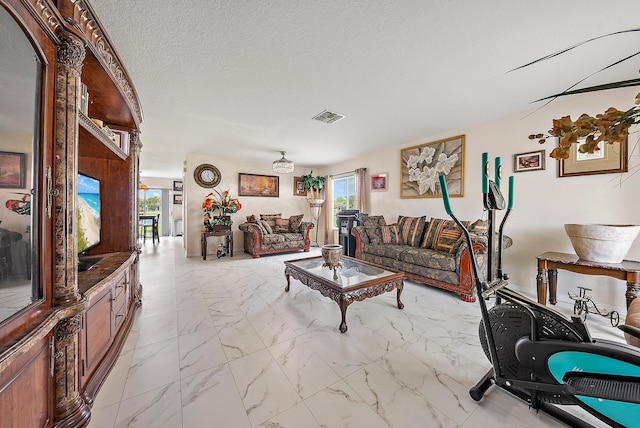 living room featuring light tile patterned floors and a textured ceiling