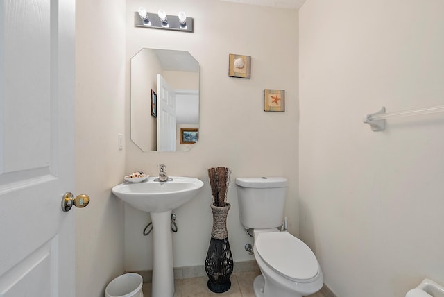 bathroom with tile patterned flooring and toilet