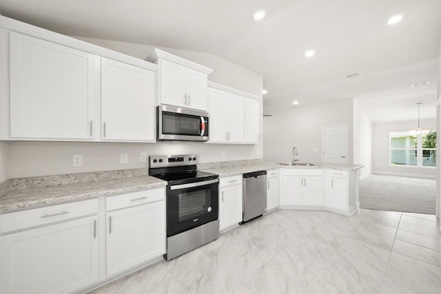 kitchen with white cabinets, appliances with stainless steel finishes, kitchen peninsula, and sink