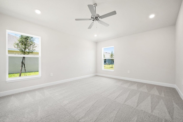 carpeted spare room with ceiling fan