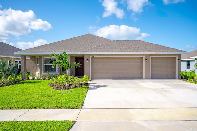 view of front of home featuring a front yard and a garage