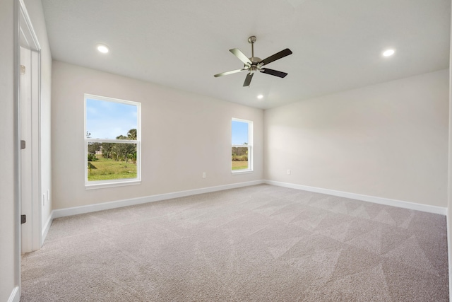 spare room with light carpet and ceiling fan