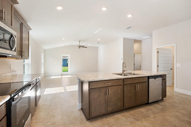 kitchen featuring ceiling fan, sink, an island with sink, vaulted ceiling, and appliances with stainless steel finishes