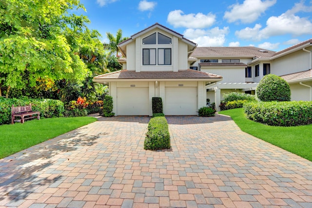 view of front of house with a front yard and a garage