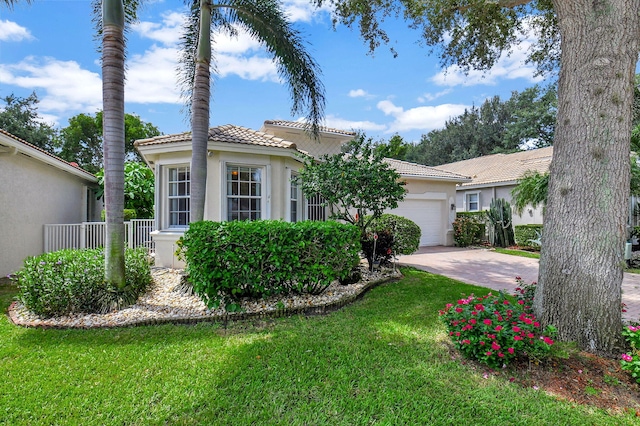 view of front facade with a garage and a front yard