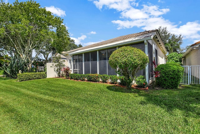 exterior space featuring a lawn and a sunroom