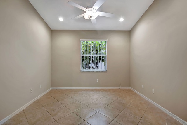 tiled spare room with ceiling fan