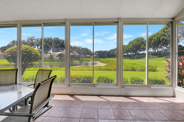 unfurnished sunroom featuring a water view and a healthy amount of sunlight