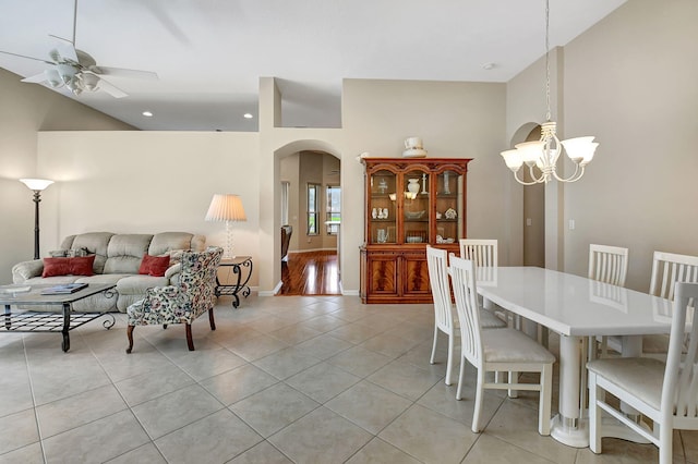 dining space featuring ceiling fan with notable chandelier and light tile patterned flooring