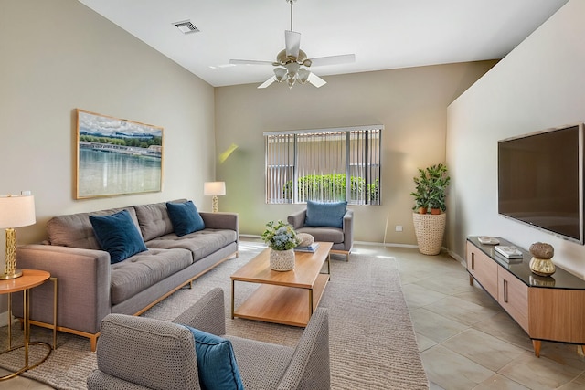 tiled living room with ceiling fan and high vaulted ceiling