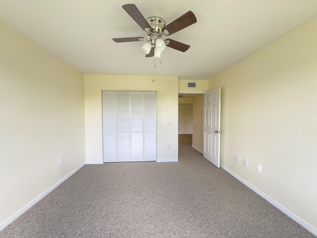 unfurnished bedroom featuring light carpet, ceiling fan, and a closet