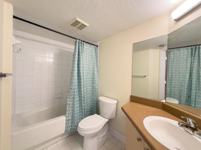 full bathroom featuring tile patterned flooring, toilet, shower / bath combination with curtain, vanity, and a textured ceiling