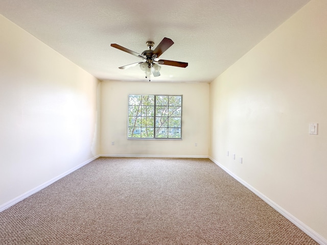 carpeted empty room with a textured ceiling and ceiling fan