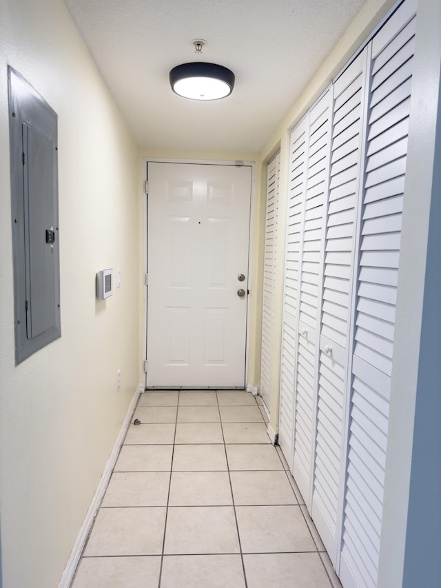 entryway with light tile patterned floors and electric panel