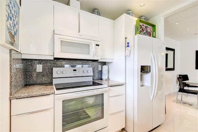 kitchen with light countertops, white appliances, white cabinetry, and tasteful backsplash