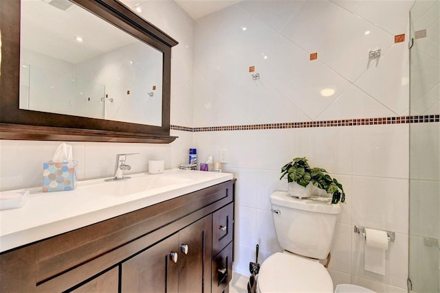 full bath featuring toilet, tile walls, and vanity