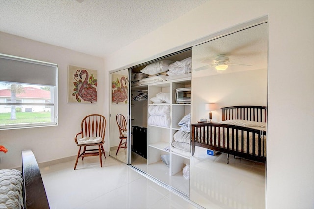 bedroom with a textured ceiling and a closet