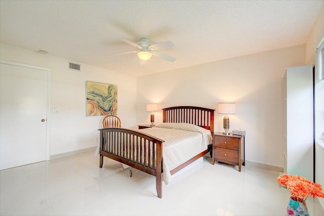 bedroom featuring baseboards, visible vents, ceiling fan, and a textured ceiling