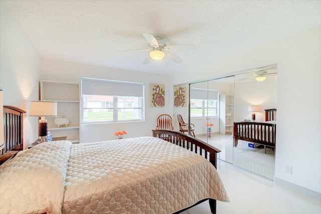 bedroom featuring ceiling fan, a closet, and a textured ceiling