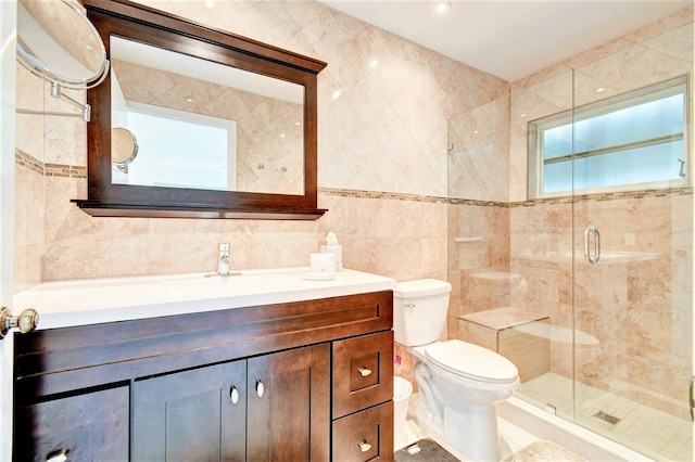 full bath featuring a stall shower, toilet, tile walls, and vanity