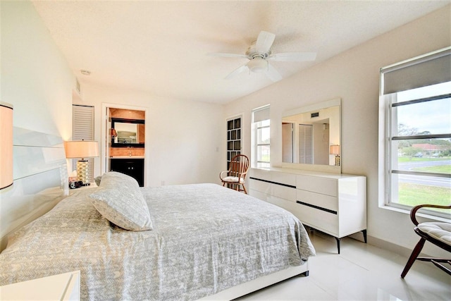 tiled bedroom with ceiling fan