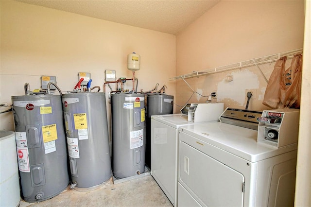 clothes washing area with electric water heater, a textured ceiling, and washer and dryer