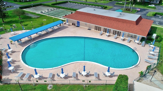 view of pool with a yard and a patio