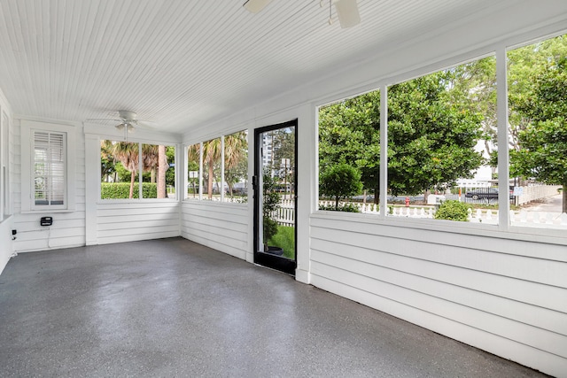 unfurnished sunroom featuring ceiling fan