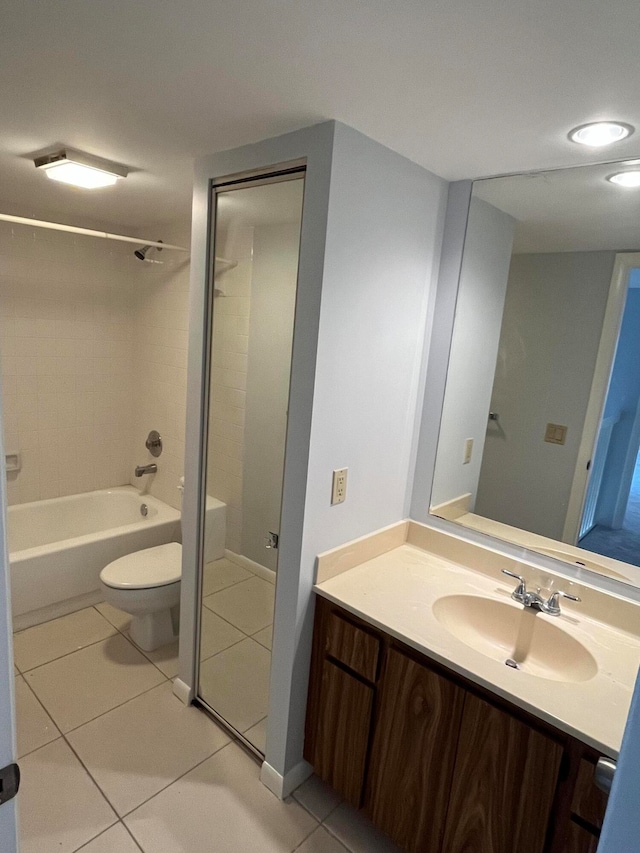 full bathroom featuring tile patterned flooring, vanity, toilet, and tiled shower / bath