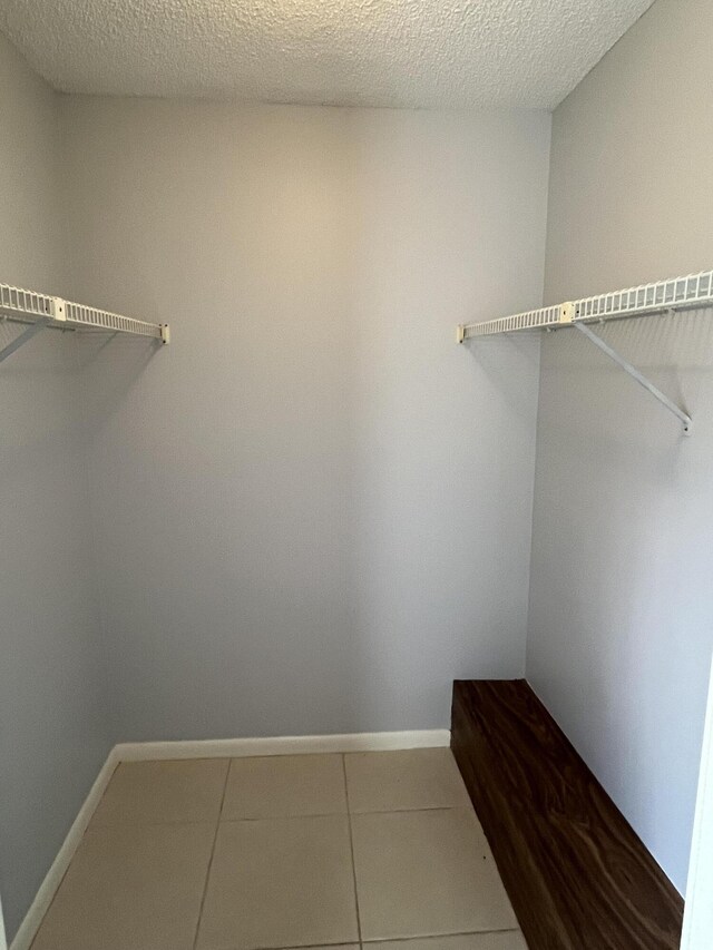 walk in closet featuring tile patterned flooring